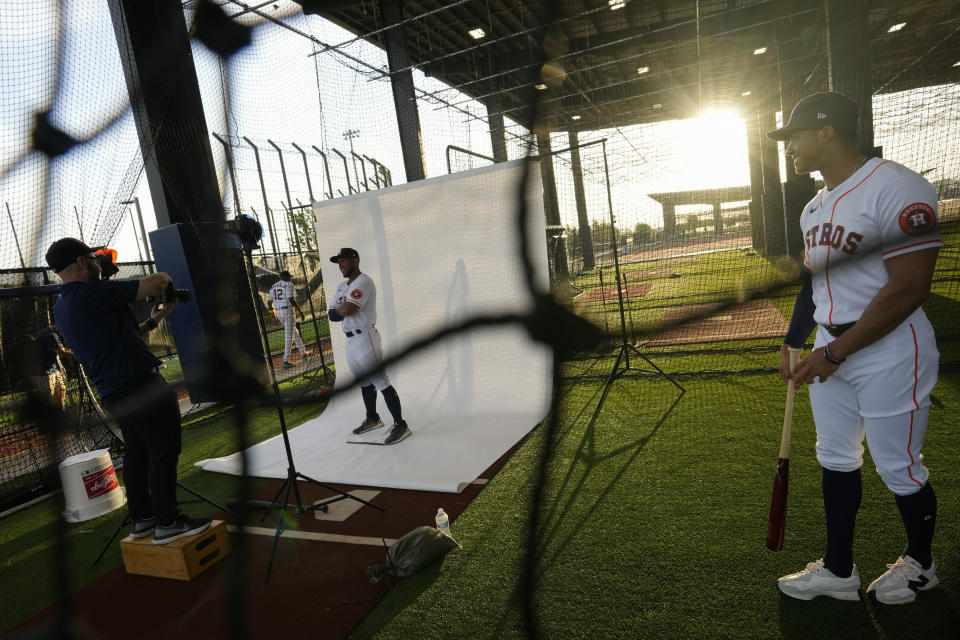 Houston Astros' Pedro Leon poses for a photographer as infielder Jeremy Pena looks on during baseball's spring training photo day Wednesday, March 16, 2022, at The Ballpark of the Palm Beaches in West Palm Beach, Fla. (AP Photo/Rebecca Blackwell)