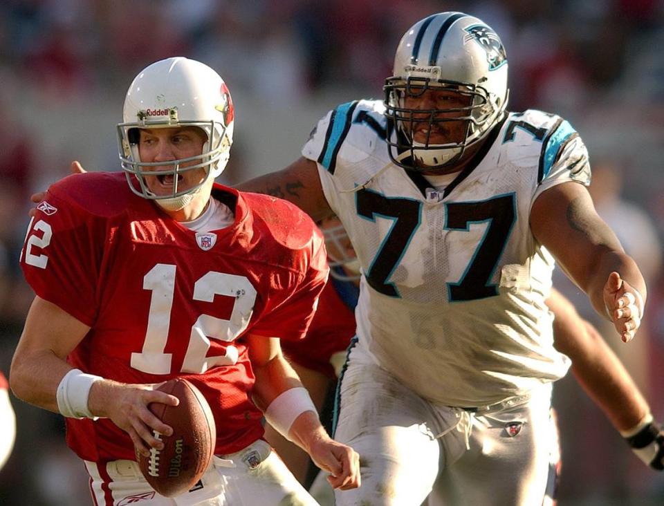 Arizona Cardinals quarterback (12) Josh McCown (12) is stalked by Carolina Panthers defensive tackle Kris Jenkins (77) in a 2003 game. Jenkins made first-team AP All-Pro that season and the Panthers advanced to the Super Bowl before losing to New England.