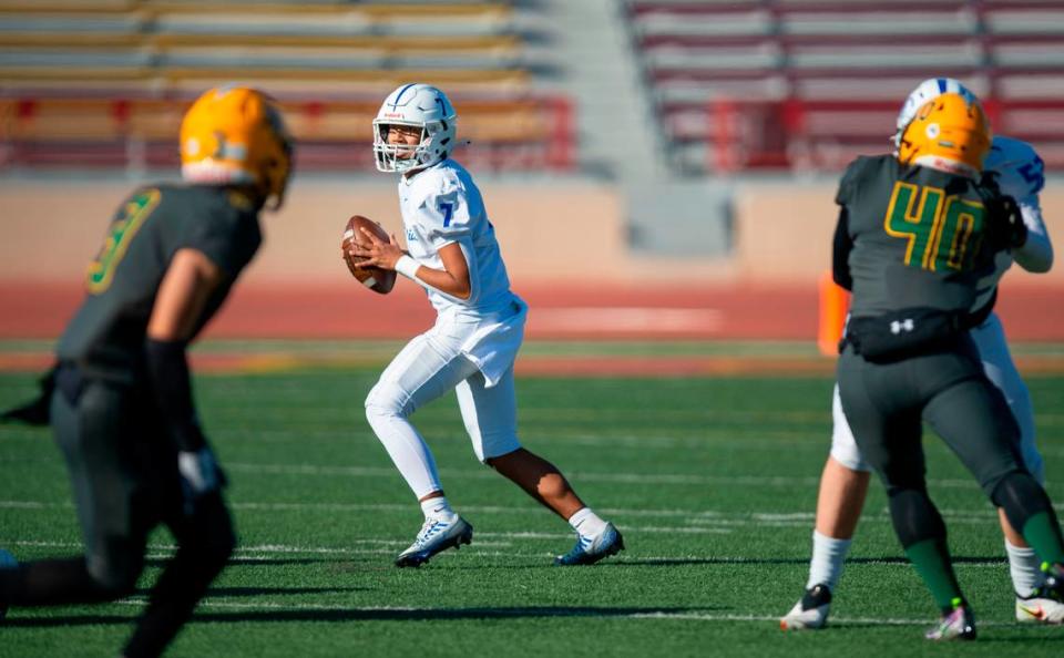 Capital Christian quarterback Eddie Brusuelas (7) steps back to pass against Vanden during the first half of the CIF Sac-Joaquin Section Division IV championship football game at Hughes Stadium in 2022.