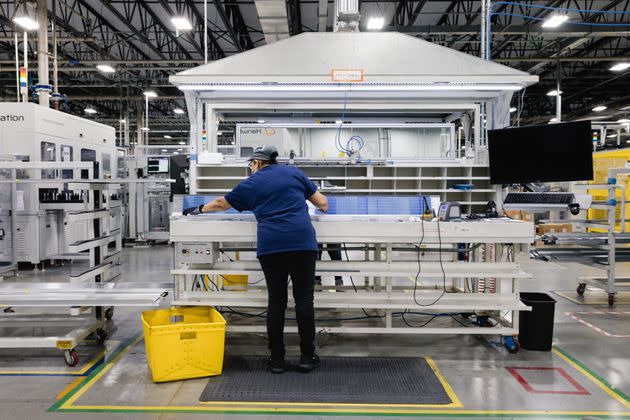 An employee performs quality control on a string of photovoltaic cells on the assembly floor at the Qcells solar panel manufacturing facility in Dalton, Georgia. China's dominance over solar manufacturing leaves America in a vulnerable place. Now, U.S. firms are racing to revive this idled industry at home. At the center of this movement is a plant in Dalton, Georgia, where solar panels are made.