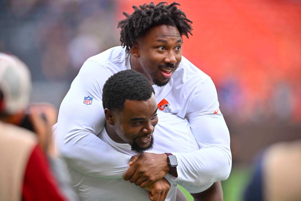 Cleveland Browns defensive end Myles Garrett, top, hops on the back of defensive tackle Jordan Elliott after an NFL preseason football game against the Philadelphia Eagles in Cleveland, Sunday, Aug. 21, 2022. (AP Photo/David Richard)