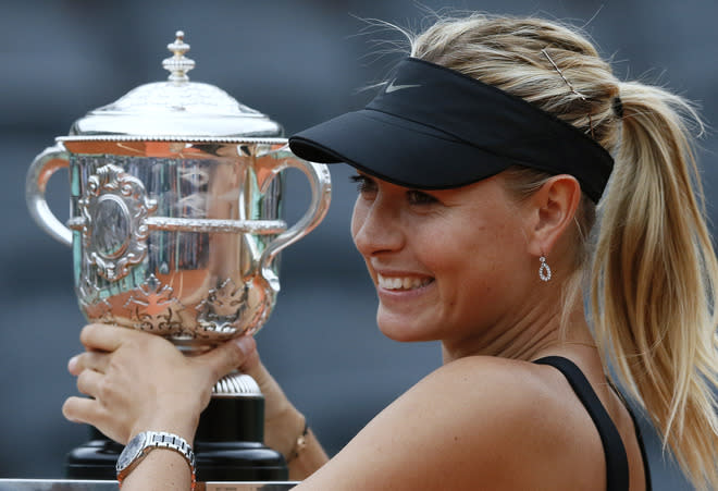 Russia's Maria Sharapova holds a trophy after winning over Italy's Sara Errani during their Women's Singles final tennis match of the French Open tennis tournament at the Roland Garros stadium, on June 9, 2012 in Paris. AFP PHOTO / PATRICK KOVARIKPATRICK KOVARIK/AFP/GettyImages