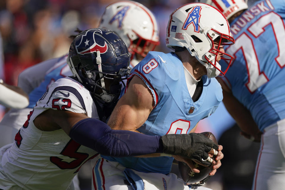Tennessee Titans quarterback Will Levis (8) is pressured by Houston Texans defensive end Jonathan Greenard (52) during the second half of an NFL football game, Sunday, Dec. 17, 2023, in Nashville, Tenn. (AP Photo/George Walker IV)