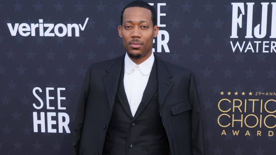 “Abbott Elementary” star Tyler James Williams wore a black Thom Browne suit with a candy stripe lining and matching brogues. - Jordan Strauss/Invision/AP