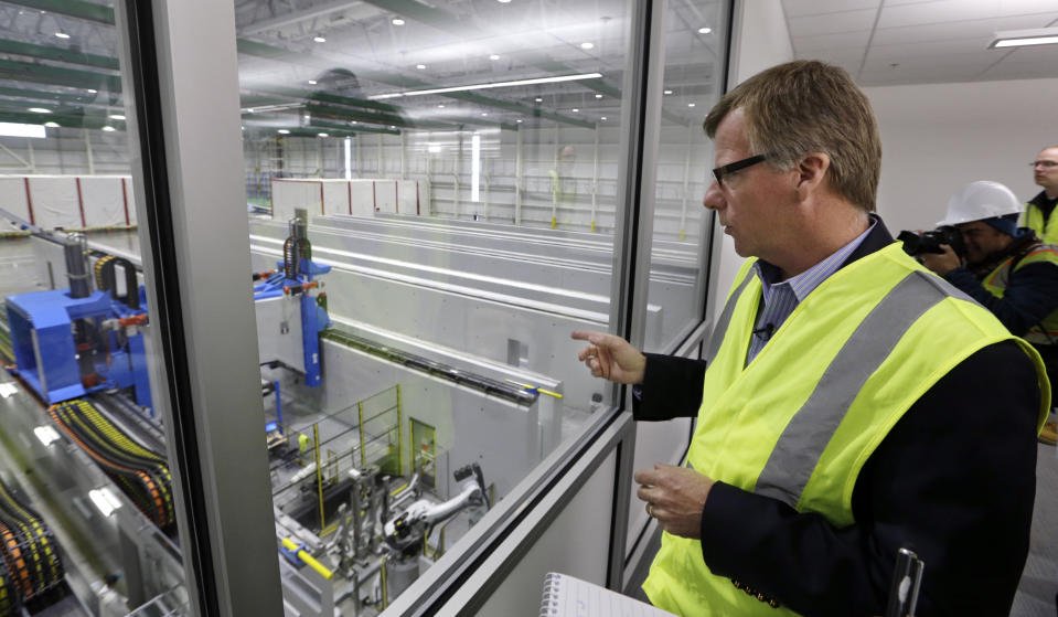 FILE - In this May 19, 2016, file photo, Eric Lindblad, vice president in charge of the Boeing 777X wing, looks over the "clean" room area of the new 777X Composite Wing Center, a day ahead of its grand opening in Everett, Wash. Lindblad, the executive who manages the Boeing 737 Max program and the Seattle-area factory where the now-grounded plane is built, said he planned to retire last summer, and a Boeing spokesman said Thursday, July 11, 2019, that Lindblad's decision was unrelated to two deadly accidents involving Max jets. (AP Photo/Elaine Thompson, File)