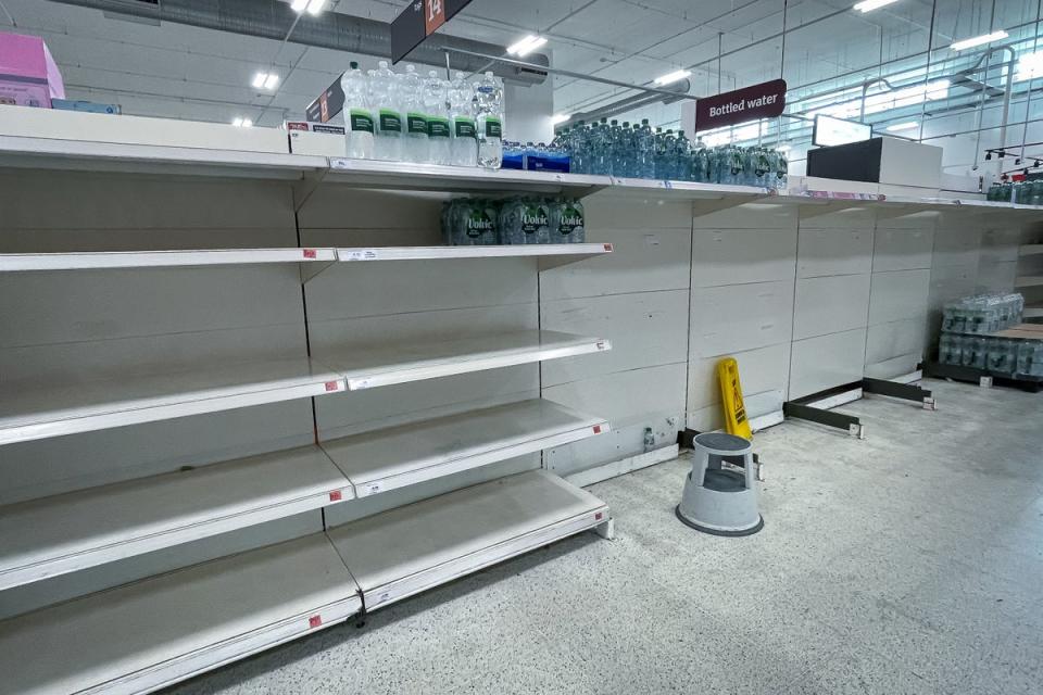 2: Empty shelves in the water aisle of Sainsbury Nine Elms in London (PA)