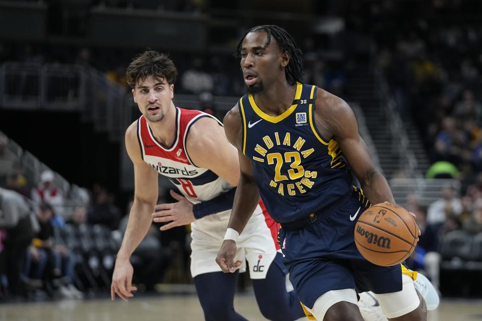 Indiana Pacers' Aaron Nesmith (23) goes to the basket against Washington Wizards' Deni Avdija (8) during the first half of an NBA basketball game Wednesday, Jan. 10, 2024, in Indianapolis. (AP Photo/Darron Cummings)