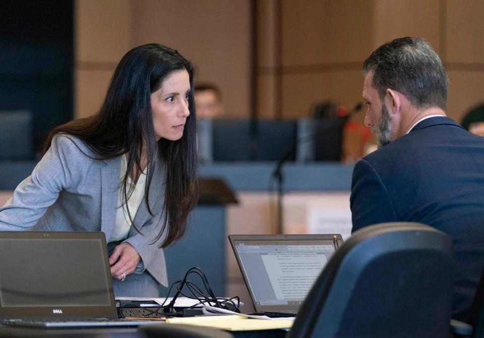 Assistant State attorneys Marci Rex and Reid Scott confer during court in the Palm Beach County Courthouse in West Palm Beach, Florida on May 4, 2021.