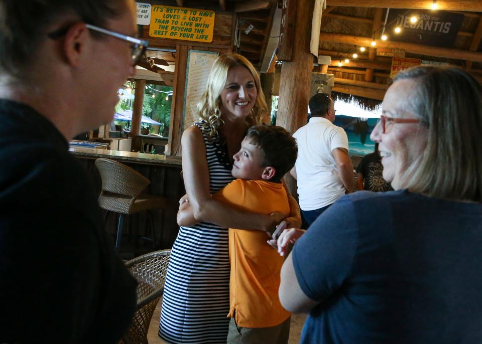 Martin School Board candidate Jennifer Russell is hugged by her son, Seth, 10, during her primary election watch party Tuesday, Aug. 23, 2022, at Harry and the Natives in Hobe Sound. Russell beat opponent Liz Bernstein and replaces incumbent Victoria Defenthaler. "Thank you to everyone who has come out and given their time," said Russell. "I appreciate them tremendously and I couldn't have gotten here without them."