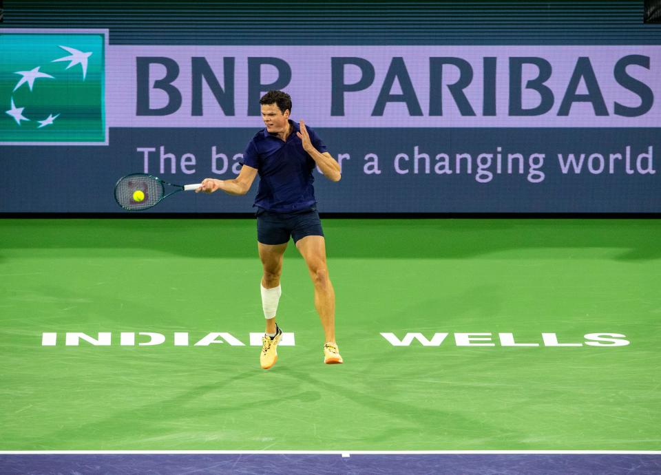 Milos Raonic hits to Sumit Nagal during round one of the BNP Paribas Open in Indian Wells, Calif., Thursday, March 7, 2024.