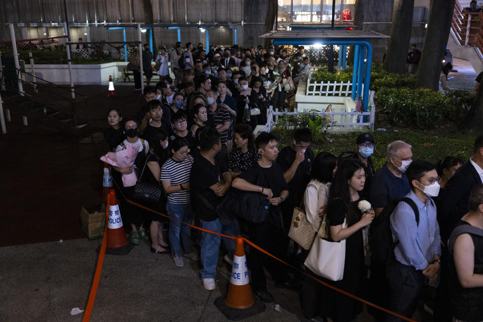 Members of the public line up to pay their respect to singer and songwriter Coco Lee outside a funeral home in Hong Kong, Monday, July 31, 2023. Lee died July 5 at age 48. (AP Photo/Louise Delmotte)