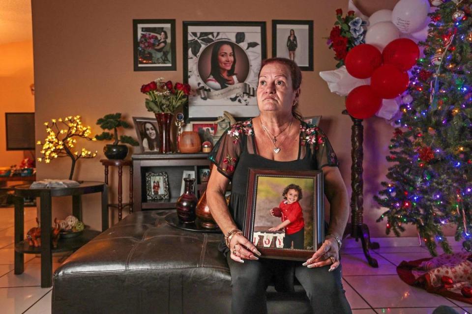 Amparo Gonzalez holds a portrait of her grandson Royce Aguerro, 3, at their home in Homestead on Tuesday, November 23, 2021. Gonzalez cares for her two grandchildren, a recent high school grad and a three-year-old boy. Her youngest daughter and the mother of her grandchildren died two years ago.