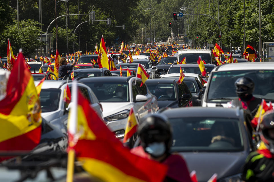 People wave Spanish flags during a drive-in protest organised by Spain's far-right Vox party against the Spanish government's handling of the nation's coronavirus outbreak in Madrid, Spain Saturday, May 23, 2020. (AP Photo/Manu Fernandez)