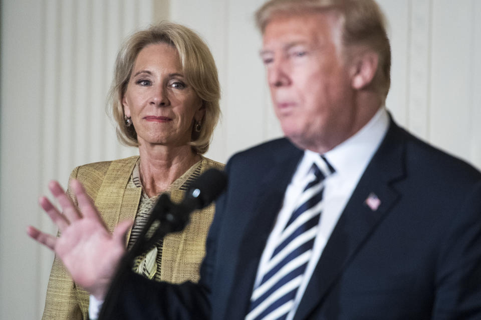 WASHINGTON, DC - MAY 2: Secretary of Education Betsy DeVos listens as President Donald J. Trump gives remarks at the National Teacher of the Year reception in the East Room of the White House on Wednesday, May 02, 2018 in Washington, DC. (Photo by Jabin Botsford/The Washington Post via Getty Images)