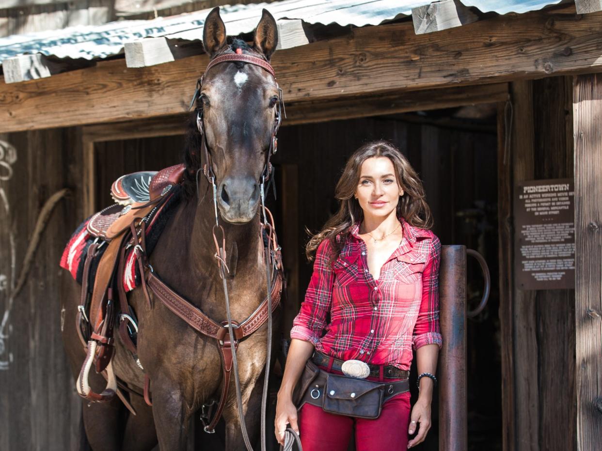 Carlotta Montanari poses with one of the horses from her horse training company, Four Legs on Set