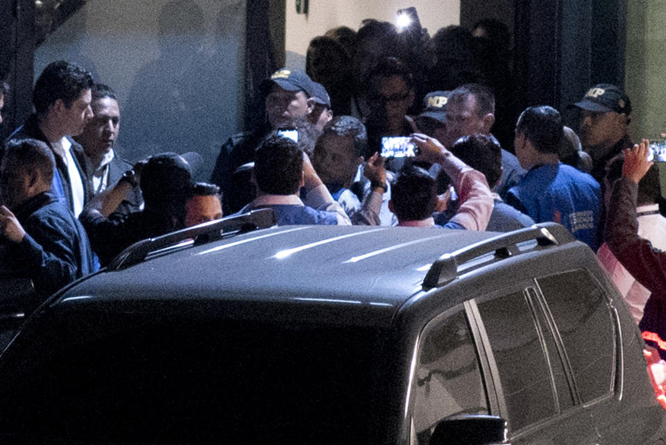 Colombian national Yilen Osorio, a member of the International Commission Against Impunity in Guatemala (CICIG), center, is embraced after entering to Guatemala at La Aurora International Airport in Guatemala City, Sunday, Jan. 6, 2019. Osorio, who was detained by immigration officials upon arrival at the airport Saturday afternoon, entered the country after a resolution by the Constitutional Court. (AP Photo/Santiago Billy)