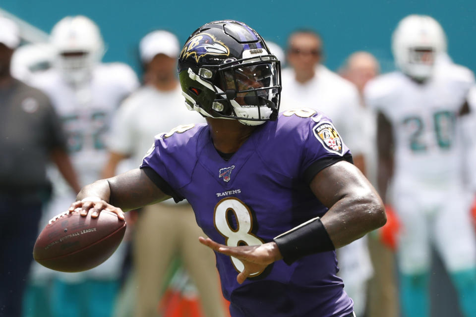 FILE - In this Sunday, Sept. 8, 2019, file photo, Baltimore Ravens quarterback Lamar Jackson (8) looks to pass during the first half at an NFL football game against the Miami Dolphins in Miami Gardens, Fla. Boosting the Ravens to the top in yards gained is an average of 541.5 yards, led by Jackson’s superb passing and running. (AP Photo/Wilfredo Lee, File)