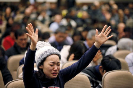 Minding Kim of Toronto raises her hands while praying for Canadian pastor Hyeon Soo Lim who is being held in North Korea during a joint multi-cultural prayer meeting at Light Korean Presbyterian Church in Toronto, December 20, 2015. REUTERS/Hyungwon Kang