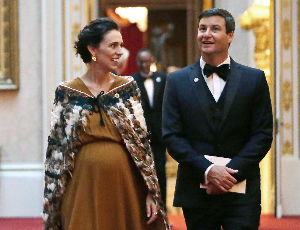 FILE - In this April 19, 2018, file photo, New Zealand's Prime Minister Jacinda Ardern and her partner Clarke Gayford arrive in the East Gallery at Buckingham Palace in London as Queen Elizabeth II hosts a dinner during the Commonwealth Heads of Government Meeting (CHOGM). New Zealand's Prime Minister Ardern on Monday, May 6, 2019, joked that her partner's marriage proposal was an intimate moment with just the two of them, a police protection officer, a couple of locals and a dog that tried to eat chocolate her partner had brought with him.(Daniel Leal-Olivas/Pool via AP, File)