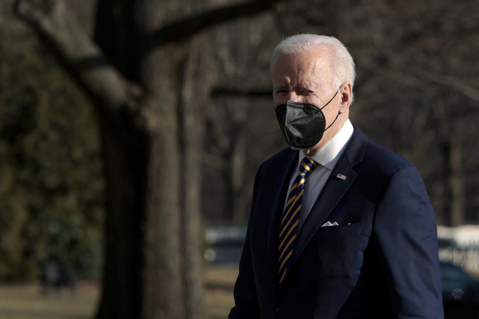 President Biden wears a mask while walking outside.