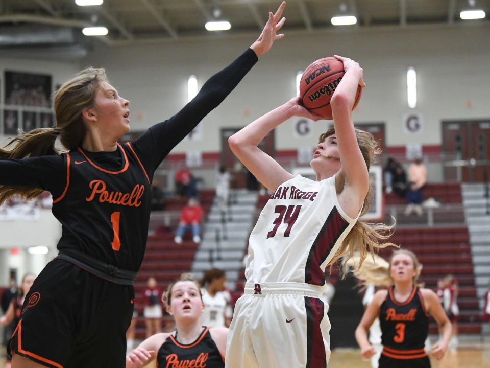 Oak Ridge's Jenna Johnson (34) shoots while guarded by Oak Ridge's Cassidy Hill (1) in the girls high school basketball game between the Oak Ridge Wildcats and Powell Panthers in Oak Ridge, Tenn. on Friday, January 21, 2022.