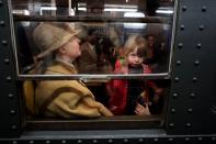 NEW YORK, NY - DECEMBER 16: A family sits in a vintage New York City subway car on December 16, 2012 in New York City. The New York Metropolitan Transportation Authority (MTA) runs vintage subway trains from the 1930's-1970's each Sunday along the M train route from Manhattan to Queens through the first of the year. (Photo by Preston Rescigno/Getty Images)