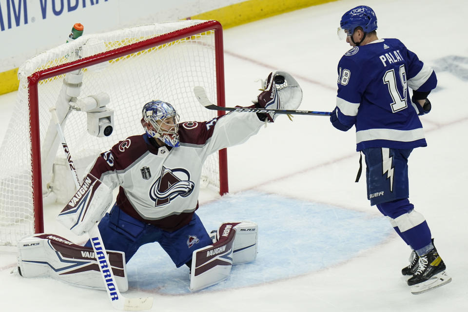 Colorado Avalanche goaltender Darcy Kuemper makes a save on a shot from Tampa Bay Lightning left wing Ondrej Palat during the first period of Game 3 of an NHL hockey Stanley Cup Final on Monday, June 20, 2022, in Tampa, Fla. (AP Photo/Chris O'Meara)