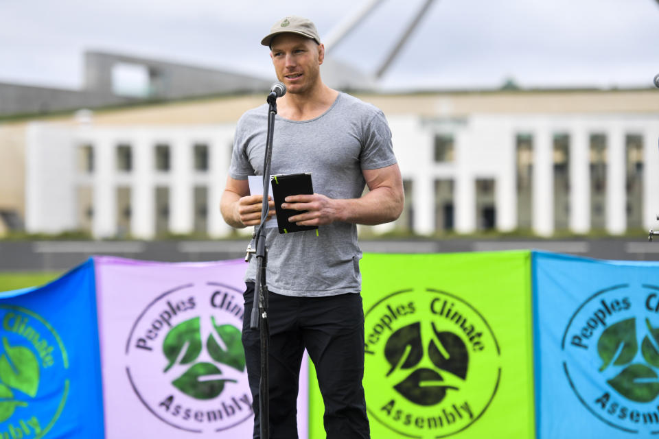 Former Wallaby player David Pocock addresses a climate change rally on the first day of the parliamentary sitting year outside Parliament House, in Canberra, Australia on Feb. 2, 2021. Election officials confirmed, Tuesday June 14, 2022 that former Wallaby Pocock has been elected as an independent senator in Australia. (Mick Tsikas/AAP Image via AP)