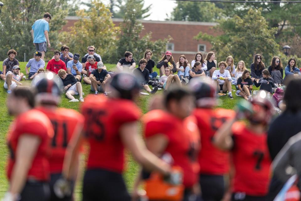 Grinnell College students watch the football game against Beloit from the hillside on Oct.1.