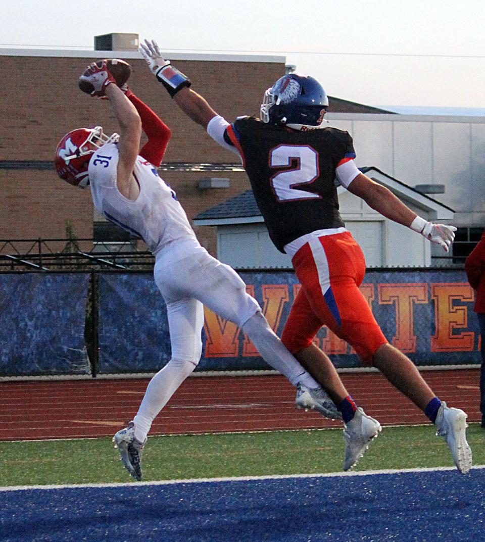 Martinsville senior Chase Mabry brings down the catch over the outstretched hands of a defender for a touchdown on a pass from junior quarterback Tyler Adkins during the Friday, Sept. 24, 2021, Mid-State Conference game at Whiteland.