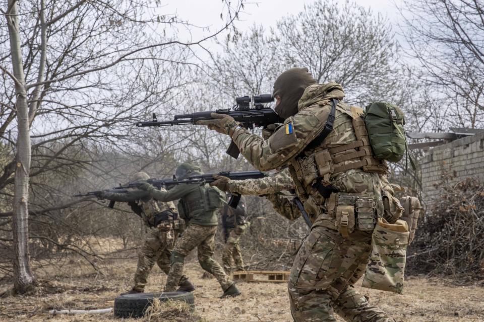 Ukrainian soldiers of the 103rd Separate Brigade of the Territorial Defense of the Armed Forces, fire their weapons, during a training exercise, at an undisclosed location, near Lviv, western Ukraine, Tuesday, March 29, 2022. (AP Photo/Nariman El-Mofty)