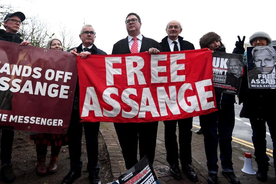 Australian MPs Andrew Wilkie (centre) and George Christensen (fourth right), stand with John Shipton, (third right), the father of WikiLeaks founder Julian Assange, outside Belmarsh prison ahead of the first day Mr Assange's extradition hearing (PA)