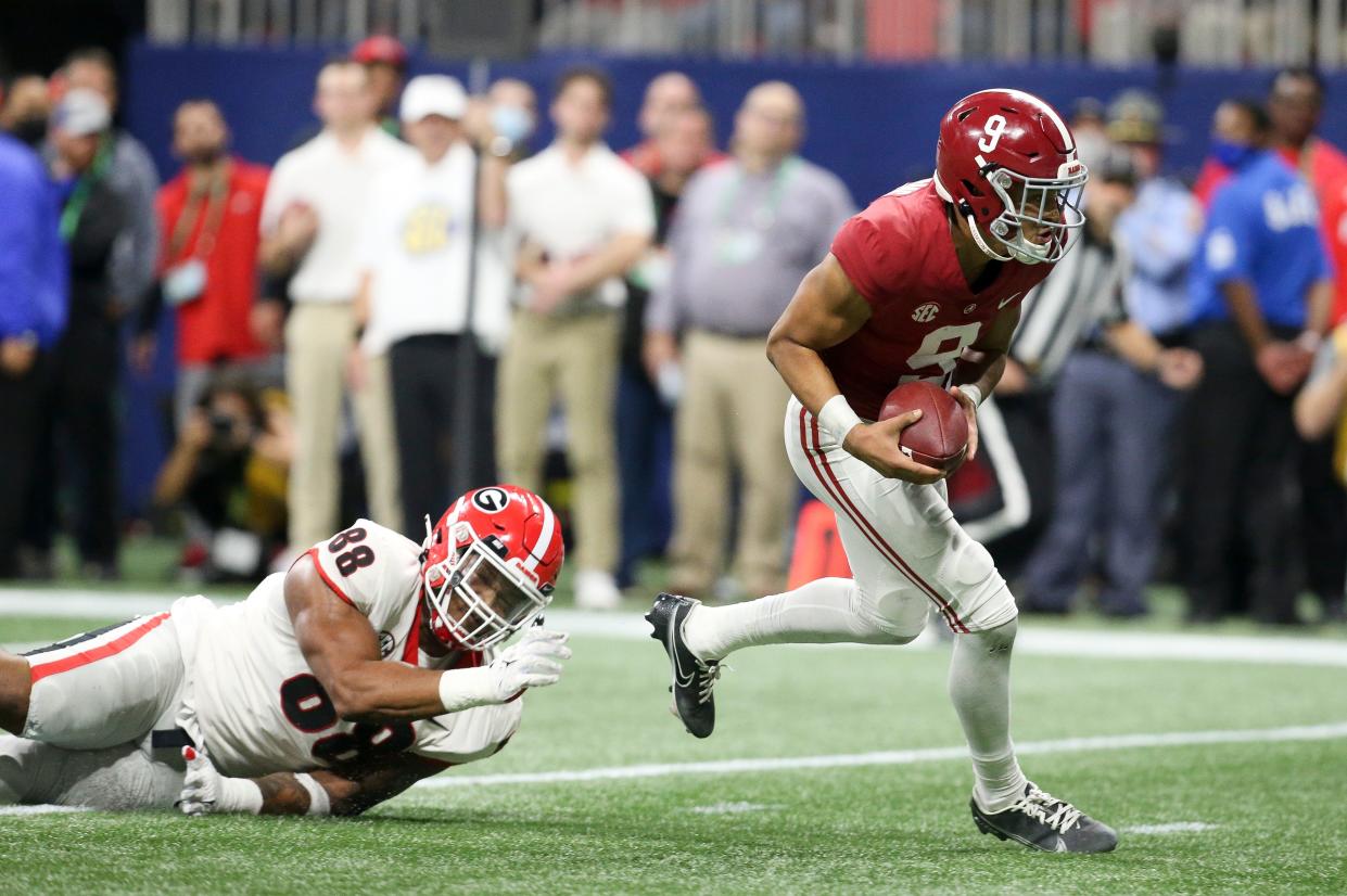 Dec 4, 2021; Atlanta, GA, USA; Alabama quarterback Bryce Young (9) evades a tackle by Georgia defensive lineman Jalen Carter (88) during the SEC championship game at Mercedes-Benz Stadium. Mandatory Credit: Gary Cosby Jr.-USA TODAY Sports