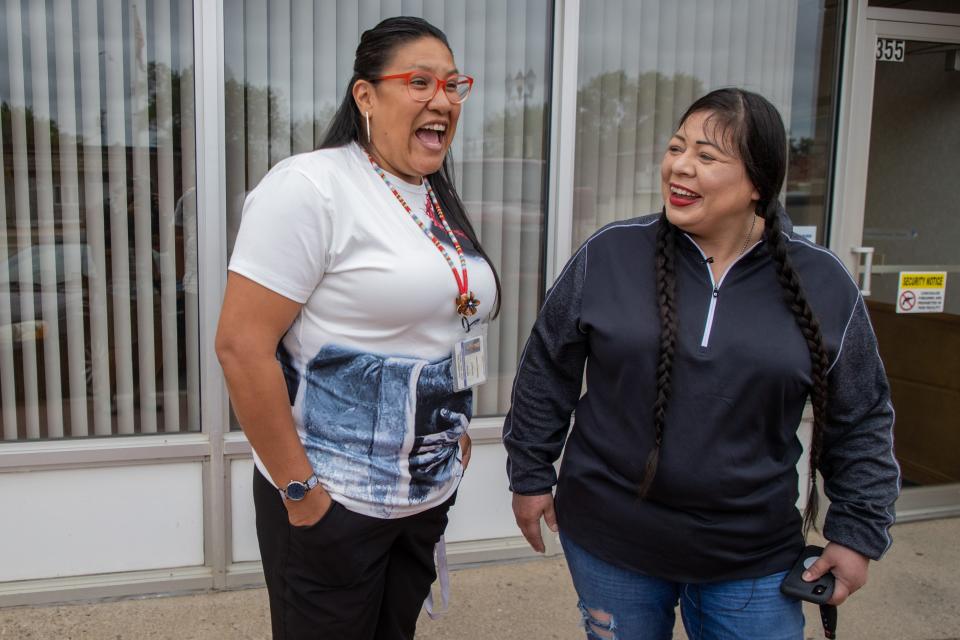 Fort Berthold Reservation resident Liea Baker, left, a former addict and current peer support specialist, has a laugh with her aunt, MHA Drug Enforcement special agent Dawn White, in downtown New Town, N.D.