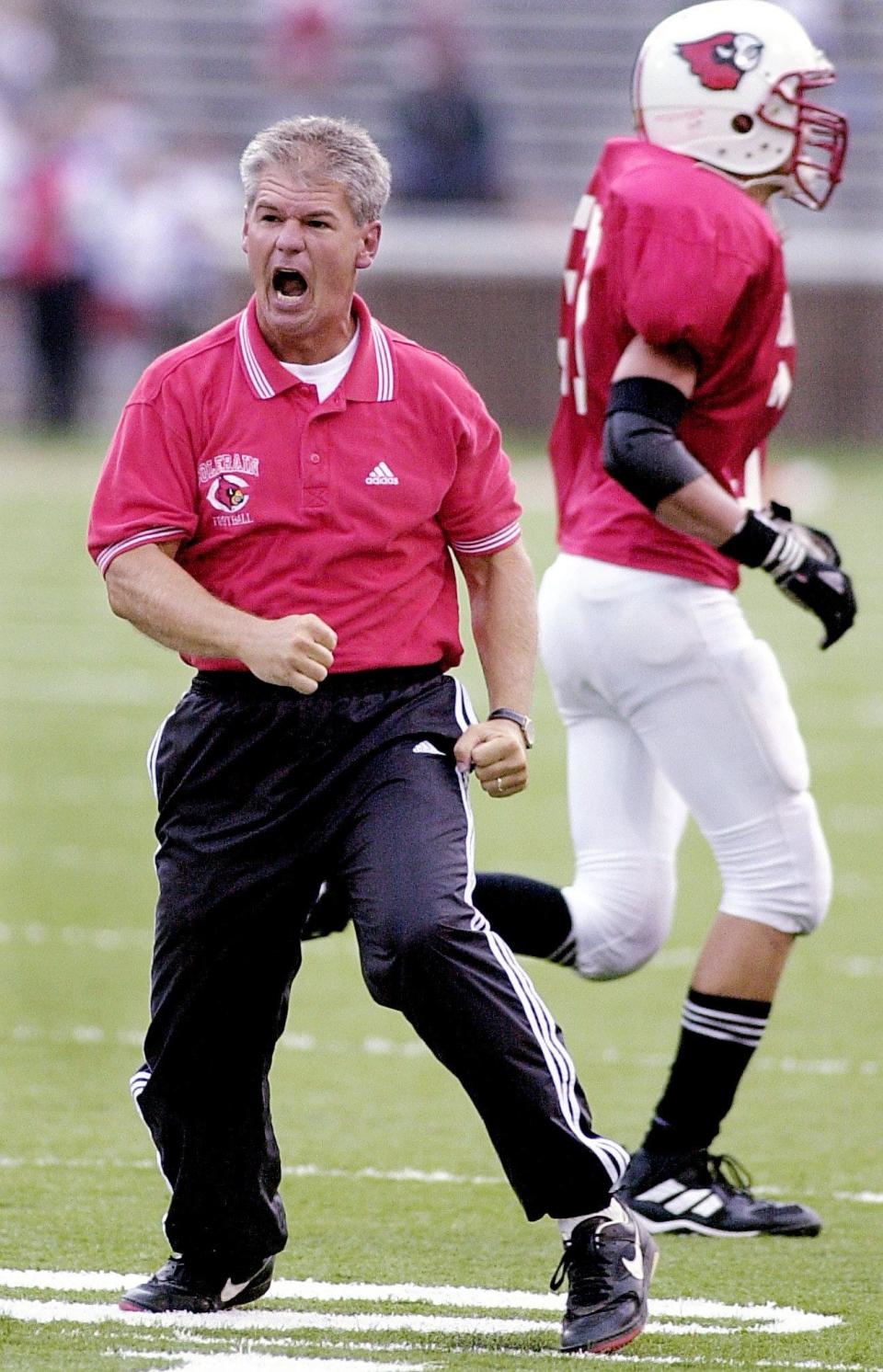 Then Colerain head coach Kerry Coombs cheers his defense as they leave the field during their game against Elder at the Crosstown Showdown at Nippert Stadium. Coombs' defense recovered a fumble to keep Elder from scoring in that play Aug. 26, 2000.