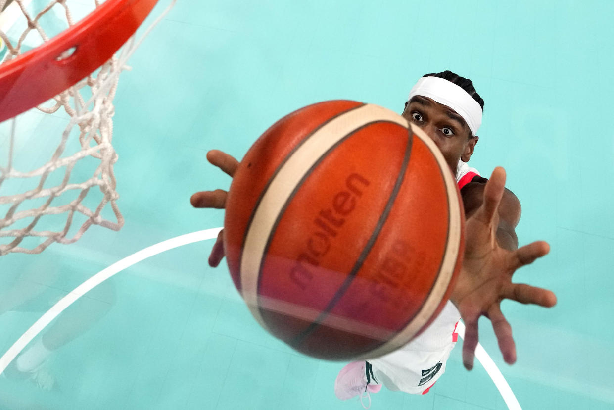 Canada's Shai Gilgeous-Alexander grabs a rebound during a men's basketball game aa; at the 2024 Summer Olympics on, July 30, 2024, in Villeneuve-d'Ascq, France. ((Michael Conro/Pool via AP)