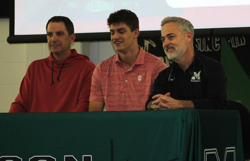 Mason senior Jake Hanley signed to play baseball for Indiana. Head coach Curt Bly is at right. Mason High School celebrated 35 seniors signing national letters of intent Feb. 7. 2024.