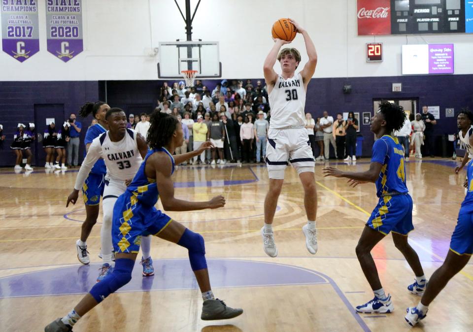 Calvary's Jake Merklinger attempts a basket during a game against Beach High.