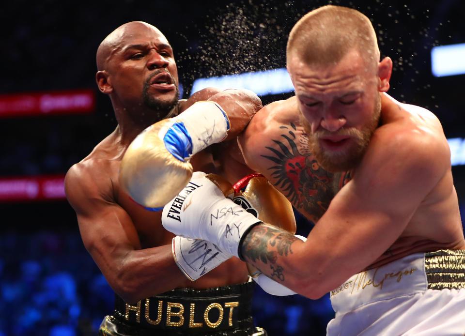 <p>Floyd Mayweather Jr. lands a hit against Conor McGregor during their boxing match at the at T-Mobile Arena. Mandatory Credit: Mark J. Rebilas-USA TODAY Sports </p>