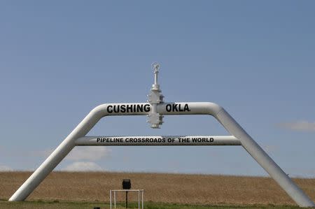 A sign built out of a pipeline that reads "pipeline crossroads of the world" welcomes visitors to town in Cushing, Oklahoma, March 24, 2016. REUTERS/Nick Oxford