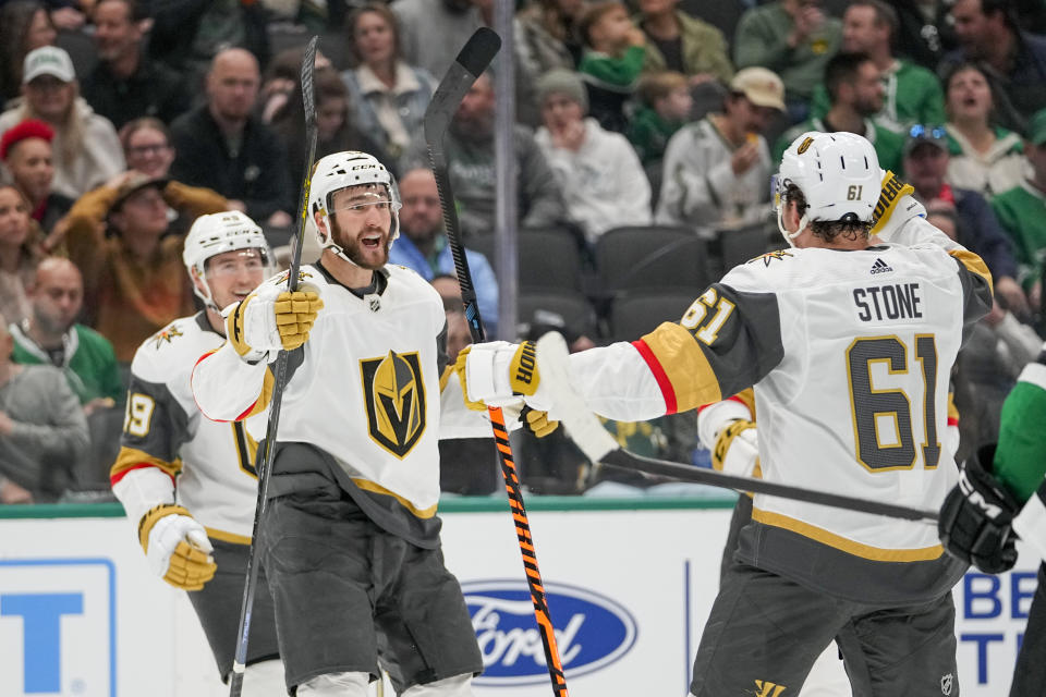 Vegas Golden Knights center Nicolas Roy, center, celebrates his goal with Mark Stone (61) and Ivan Barbashev (49) during the second period of an NHL hockey game against the Dallas Stars, Saturday, Dec. 9, 2023, in Dallas. (AP Photo/Julio Cortez)