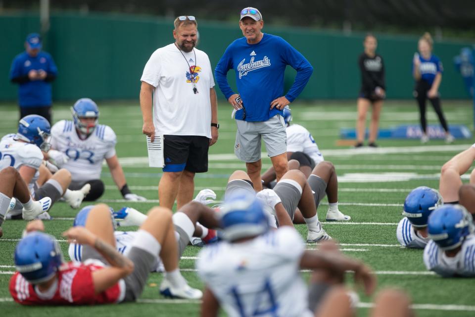 Kansas head football coach Lance Leipold, right, talks with offensive coordinator Andy Kotelnicki, left, as players begin practice one morning during the fall of 2022.