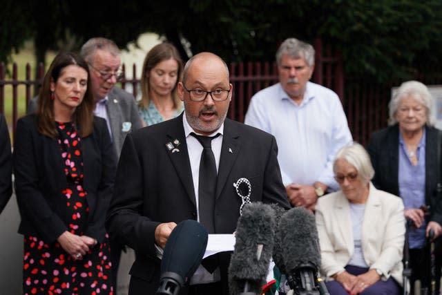 Stuart Stephens, the father of Olly Stephens, reads a statement outside Reading Crown Court beside his mother Amanda 