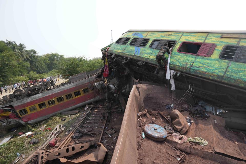 Rescuers work at the site of passenger trains that derailed in Balasore district, in the eastern Indian state of Orissa, Saturday, June 3, 2023. Rescuers are wading through piles of debris and wreckage to pull out bodies and free people after two passenger trains derailed in India, killing more than 280 people and injuring hundreds as rail cars were flipped over and mangled in one of the country’s deadliest train crashes in decades. (AP Photo/Rafiq Maqbool)