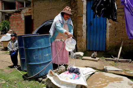 A woman throws to laundry during water drought season in Uni near La Paz, Bolivia, November 28, 2016. REUTERS/David Mercado