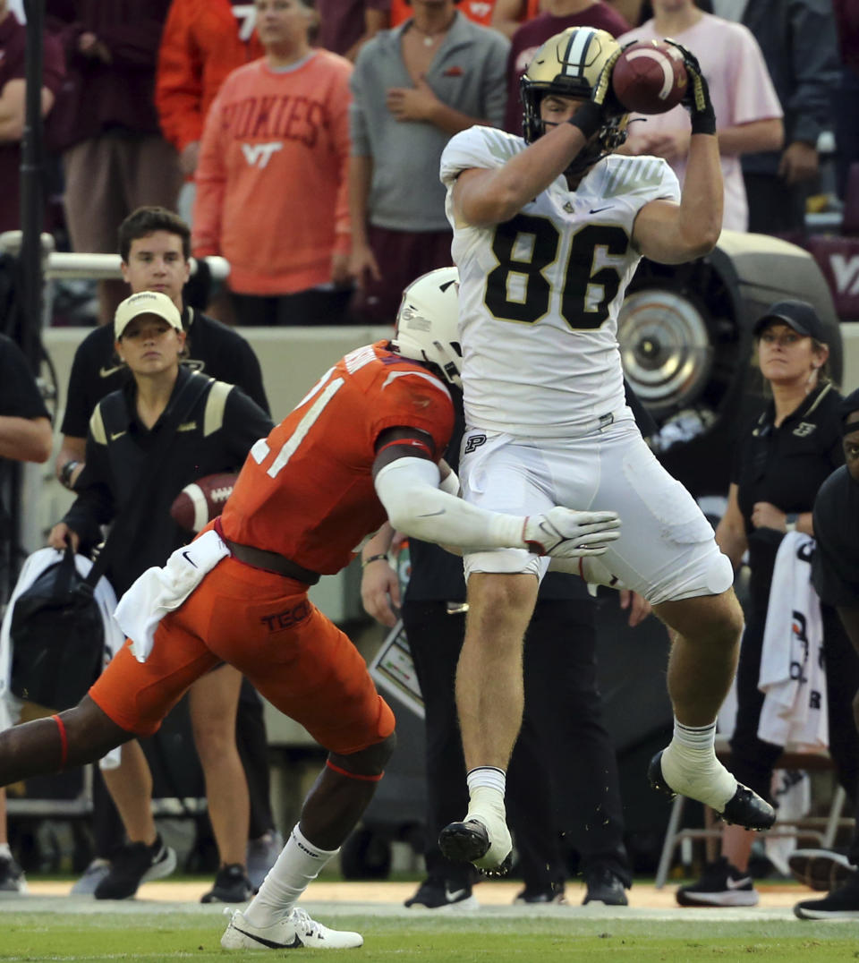 Purdue's Max Klare (86) is hit and pushed out of bounds by Virginia Tech linebacker Keli Lawson (21) in the second quarter of an NCAA college football game in Blacksburg, Va., Saturday, Sept. 9 2023. (Matt Gentry/The Roanoke Times via AP)