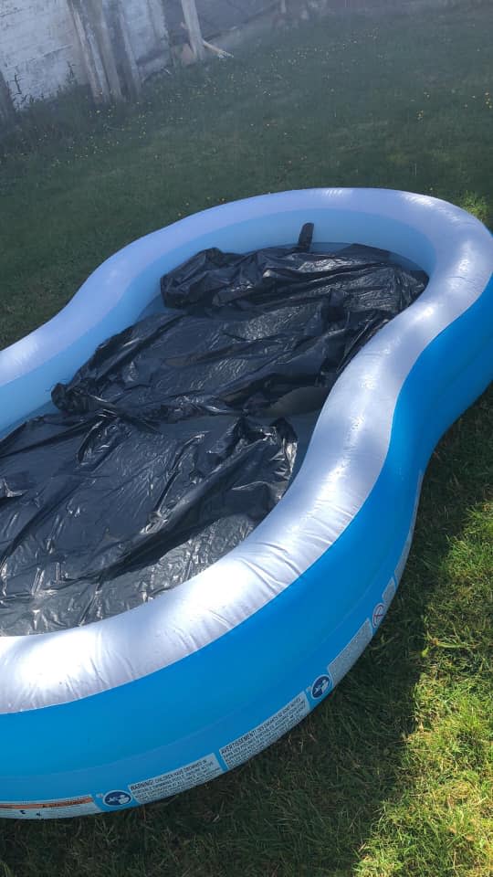 Blow up pool in Bolton, UK, that family used black tarp in effort to make water warm.