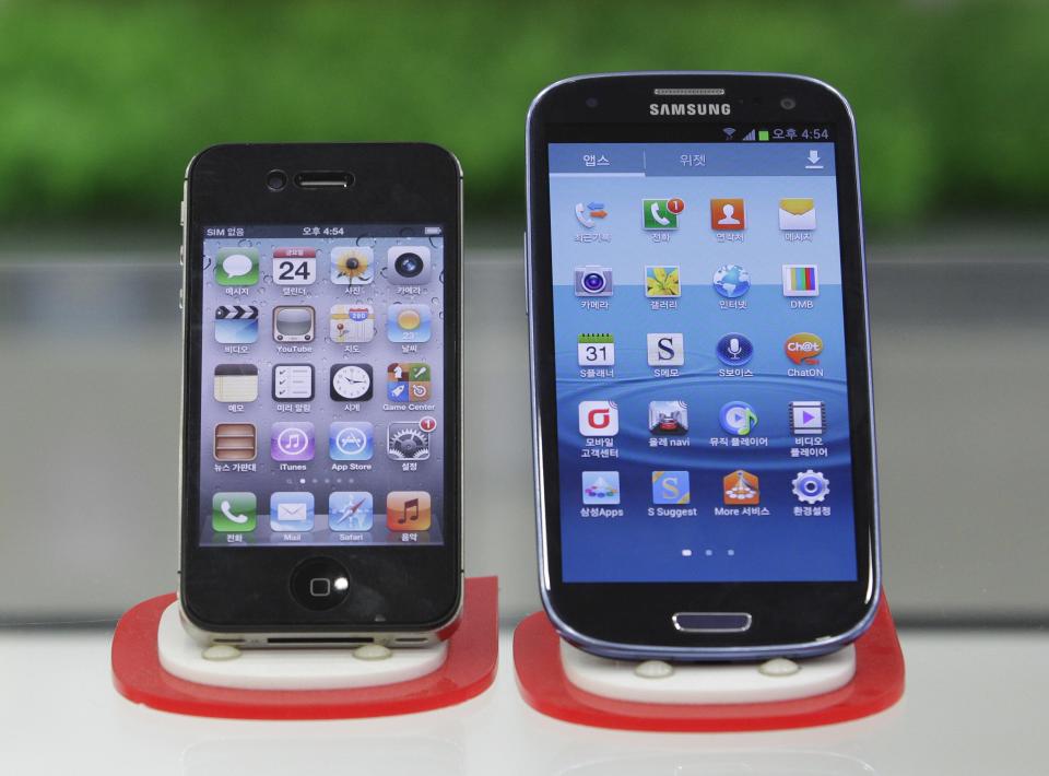 Samsung Electronics' Galaxy S III, right, and Apple's iPhone 4S are displayed at a mobile phone shop in Seoul, South Korea, Friday, Aug. 24, 2012. South Korea's Samsung won a home court ruling in its global smartphone battle against Apple on Friday when Seoul judges said the company didn't copy the look and feel of the U.S. company's iPhone, and that Apple infringed on Samsung's wireless technology. However, in a split decision on patents, the panel also said Samsung violated Apple technology behind the bounce-back feature when scrolling on touch screens, and ordered both sides to pay limited damages. (AP Photo/Ahn Young-joon)