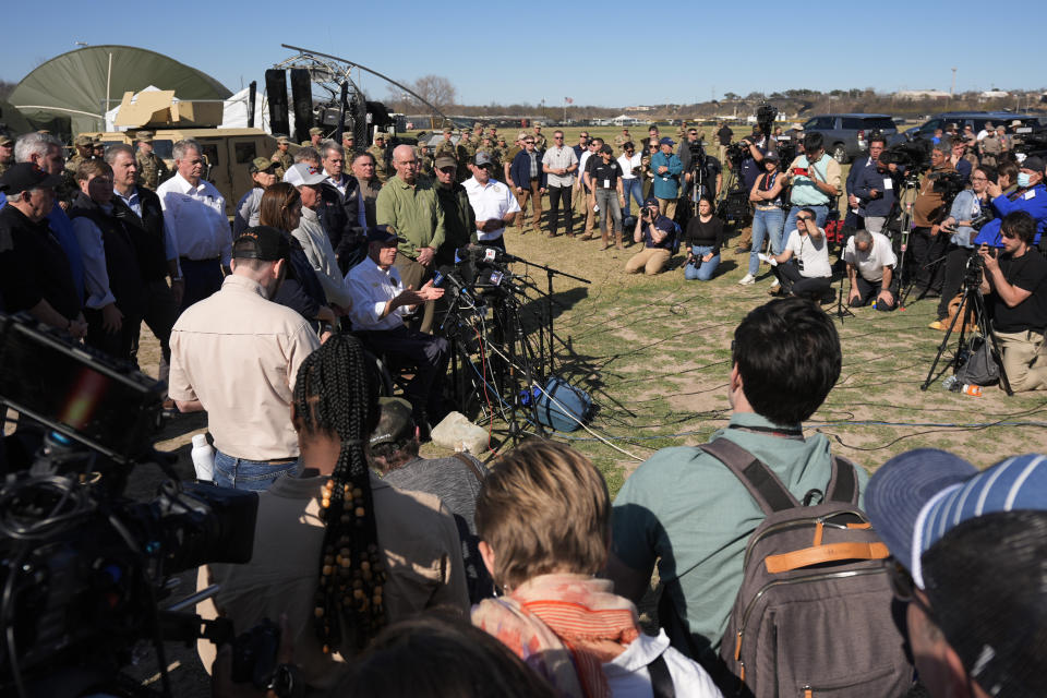 Texas Gov. Greg Abbott, seated center, is surrounded by fellow governors and members of the media during a news conference along the Rio Grande to discuss Operation Lone Star and border concerns, Sunday, Feb. 4, 2024, in Eagle Pass, Texas. Abbott returned to the Eagle Pass border to highlight his escalating attempts to curb illegal crossings on the U.S.-Mexico border. He was joined Sunday afternoon by more than a dozen other GOP governors, all of whom have cheered on his extraordinary showdown with the Biden administration over immigration enforcement. (AP Photo/Eric Gay)