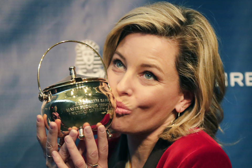 Actor and director Elizabeth Banks kisses the Hasty Pudding Pot after being honored as the 2020 Woman of the Year by Harvard University's Hasty Pudding Theatricals, Friday, Jan. 31, 2020, in Cambridge, Mass. (AP Photo/Elise Amendola)